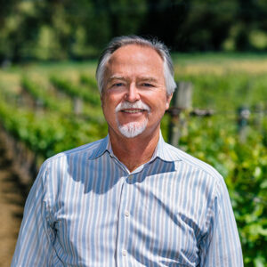 Scott McAdams in front of a client vineyard